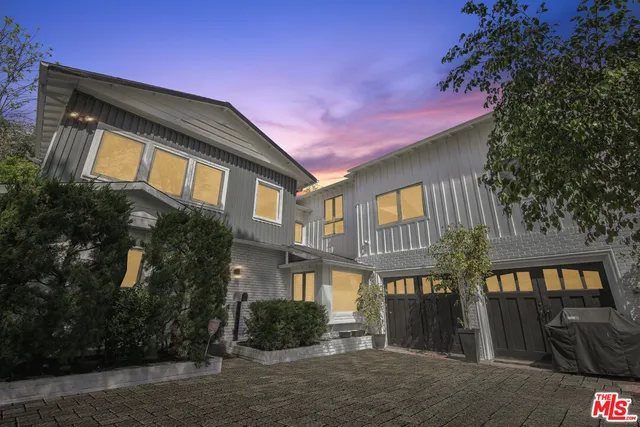 a front view of a residential apartment building with a yard