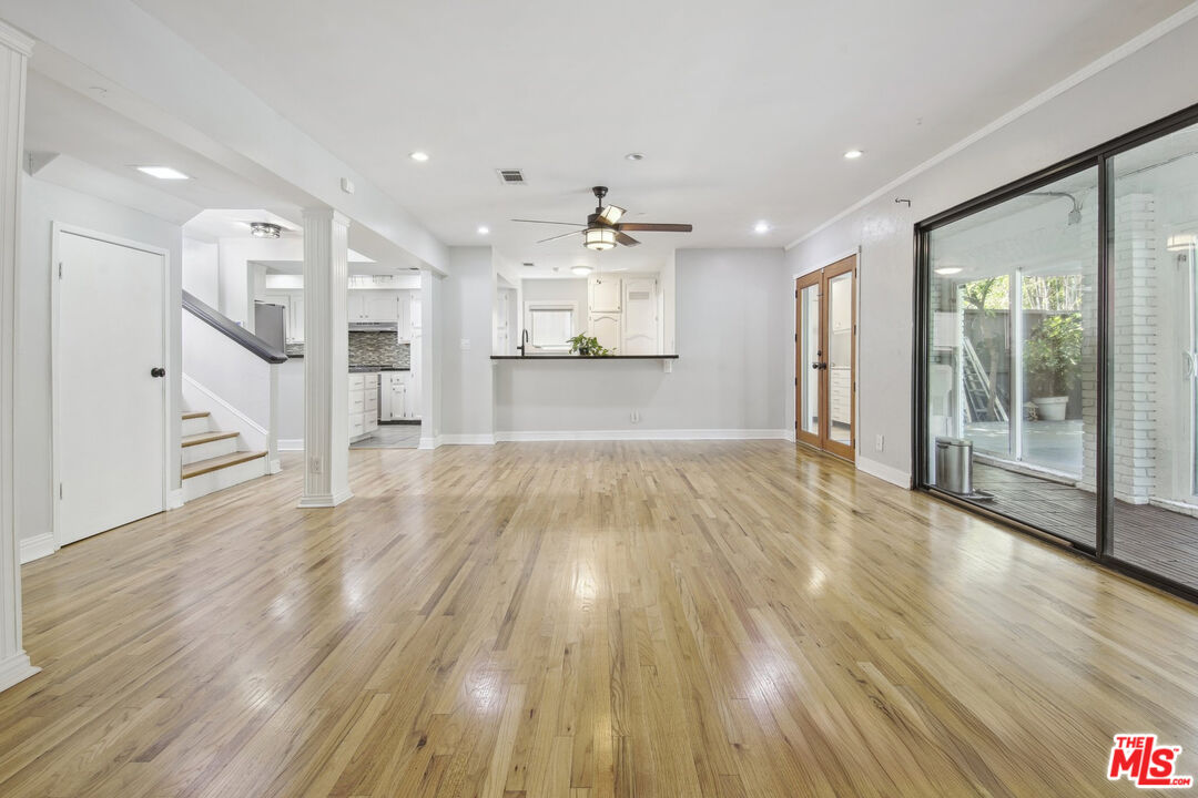 5527 Columbus Avenue Sherman Oaks, CA 91411 - Photo 5 of 29 a view of an empty room and kitchen with wooden floor