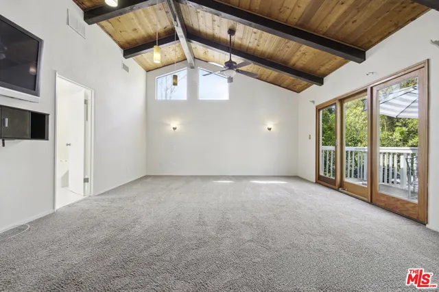 a spacious bedroom with a bed and a large window