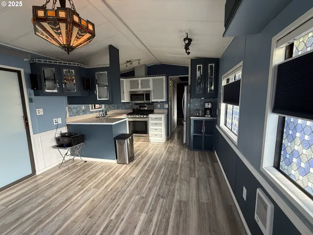 a kitchen with stainless steel appliances granite countertop a stove and a sink