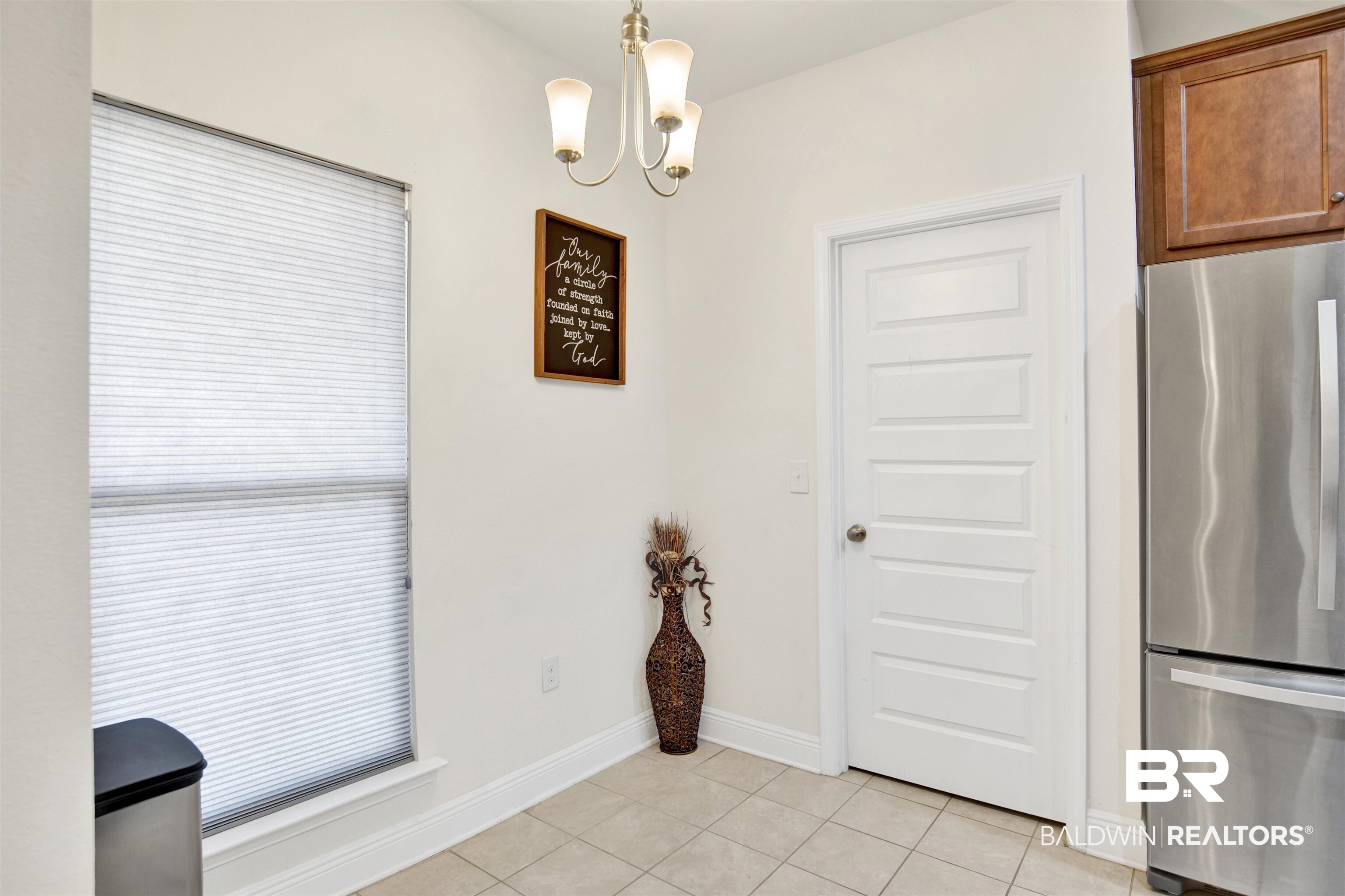 1468 Surrey Loop Foley, AL 36535 - Photo 6 of 28 Dining space featuring light tile patterned flooring, a chandelier, and baseboards