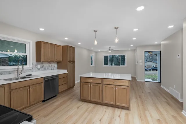 a kitchen with a sink stove and microwave