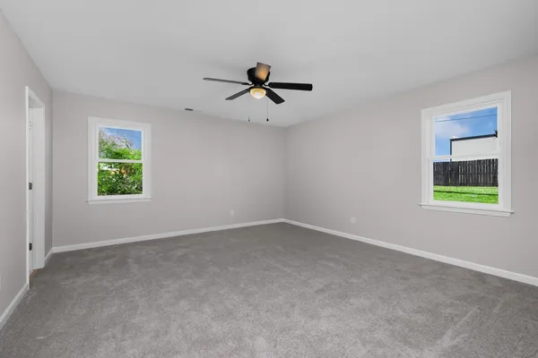 a large kitchen with a large counter top a sink stainless steel appliances and cabinets