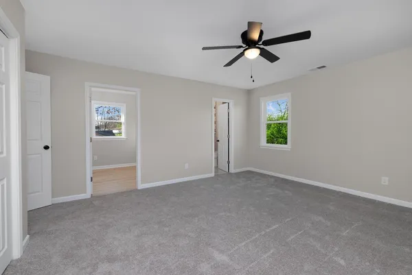 a view of a livingroom with a ceiling fan and window