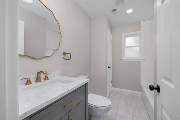 an empty room with a ceiling fan and window