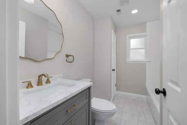 an empty room with a ceiling fan and window