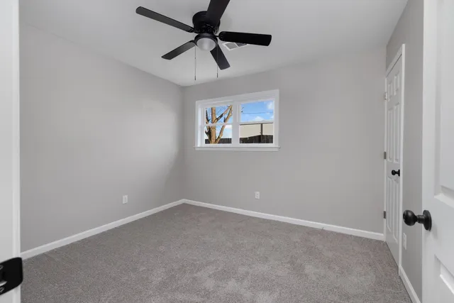 a bathroom with a granite countertop sink a toilet and a mirror