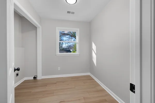 a view of an empty room and a window