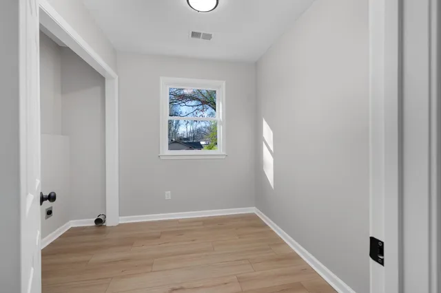 a view of an empty room and a window