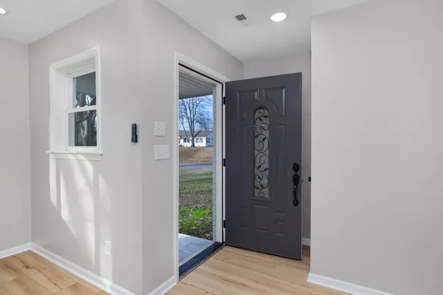 an entryway with a bookshelf