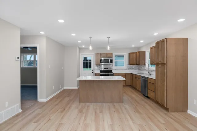 a view of a kitchen with a sink and wooden floor