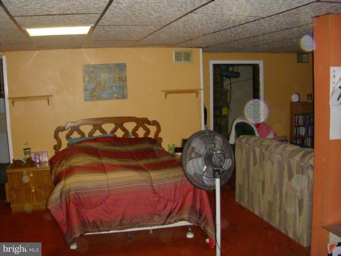 339 Sassafras Road Baltimore, MD 21221 - Photo 12 of 20 a bedroom with a bed and dresser