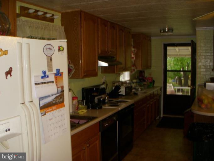 339 Sassafras Road Baltimore, MD 21221 - Photo 4 of 20 a kitchen with a sink and a stove top oven
