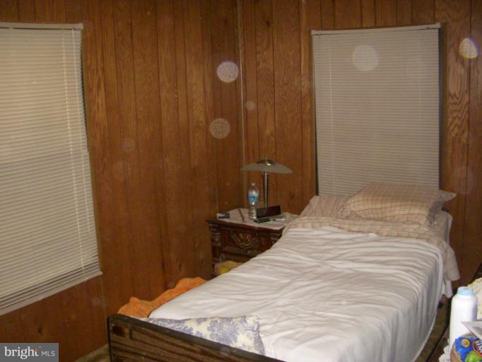 339 Sassafras Road Baltimore, MD 21221 - Photo 9 of 20 a bedroom with a bed and wooden floor