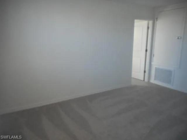 a open kitchen with stainless steel appliances granite countertop a stove a sink a refrigerator with white cabinets and wooden floor