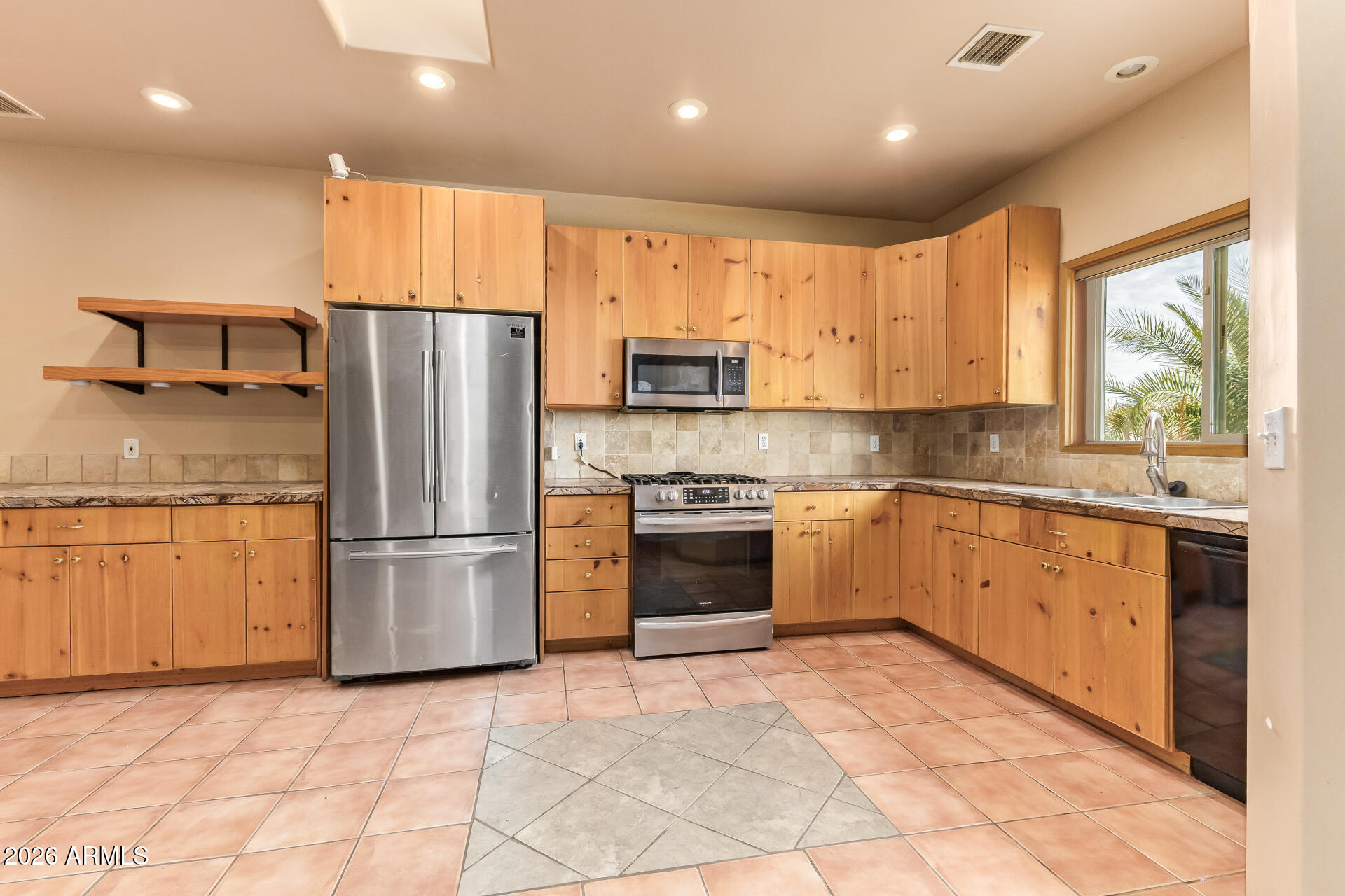 15137 South Moon Valley Road Arizona City, AZ 85123 - Photo 12 of 35 a kitchen with a refrigerator and a sink