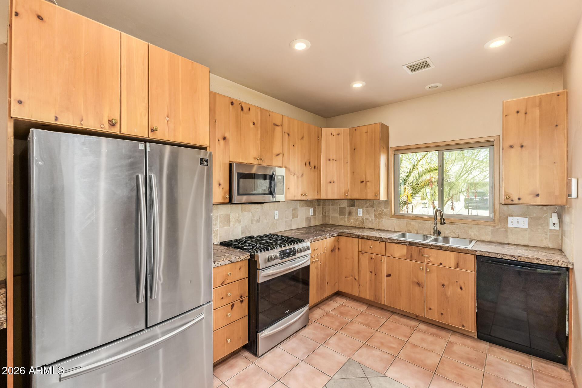 15137 South Moon Valley Road Arizona City, AZ 85123 - Photo 13 of 35 a kitchen with stainless steel appliances a sink cabinets and a window