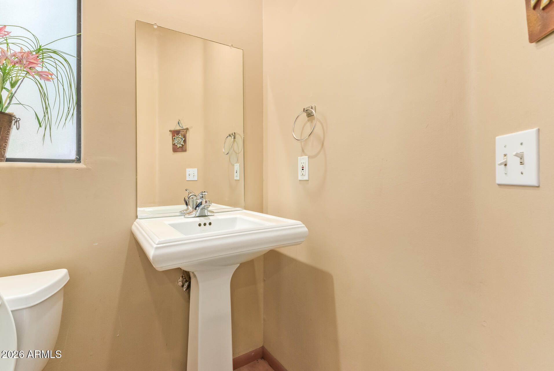 15137 South Moon Valley Road Arizona City, AZ 85123 - Photo 14 of 35 a bathroom with a sink a mirror and a toilet