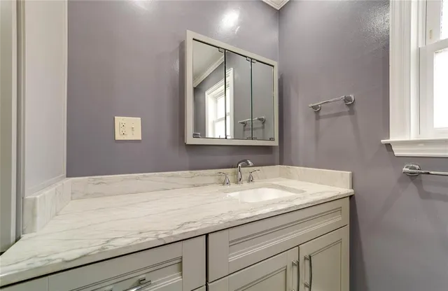 a bathroom with a sink and a mirror