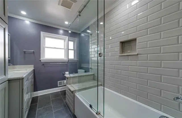 a bathroom with a bathtub and a shower