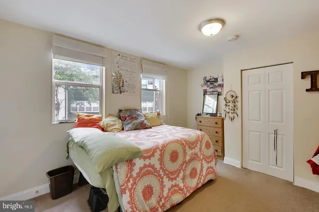 a bedroom with a bed and window