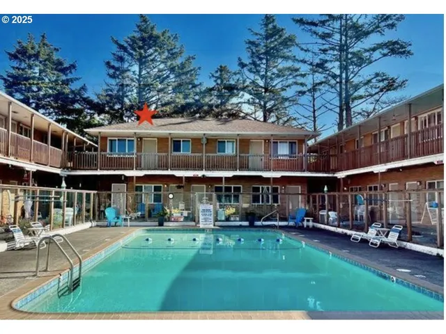 a front view of a building with a garden