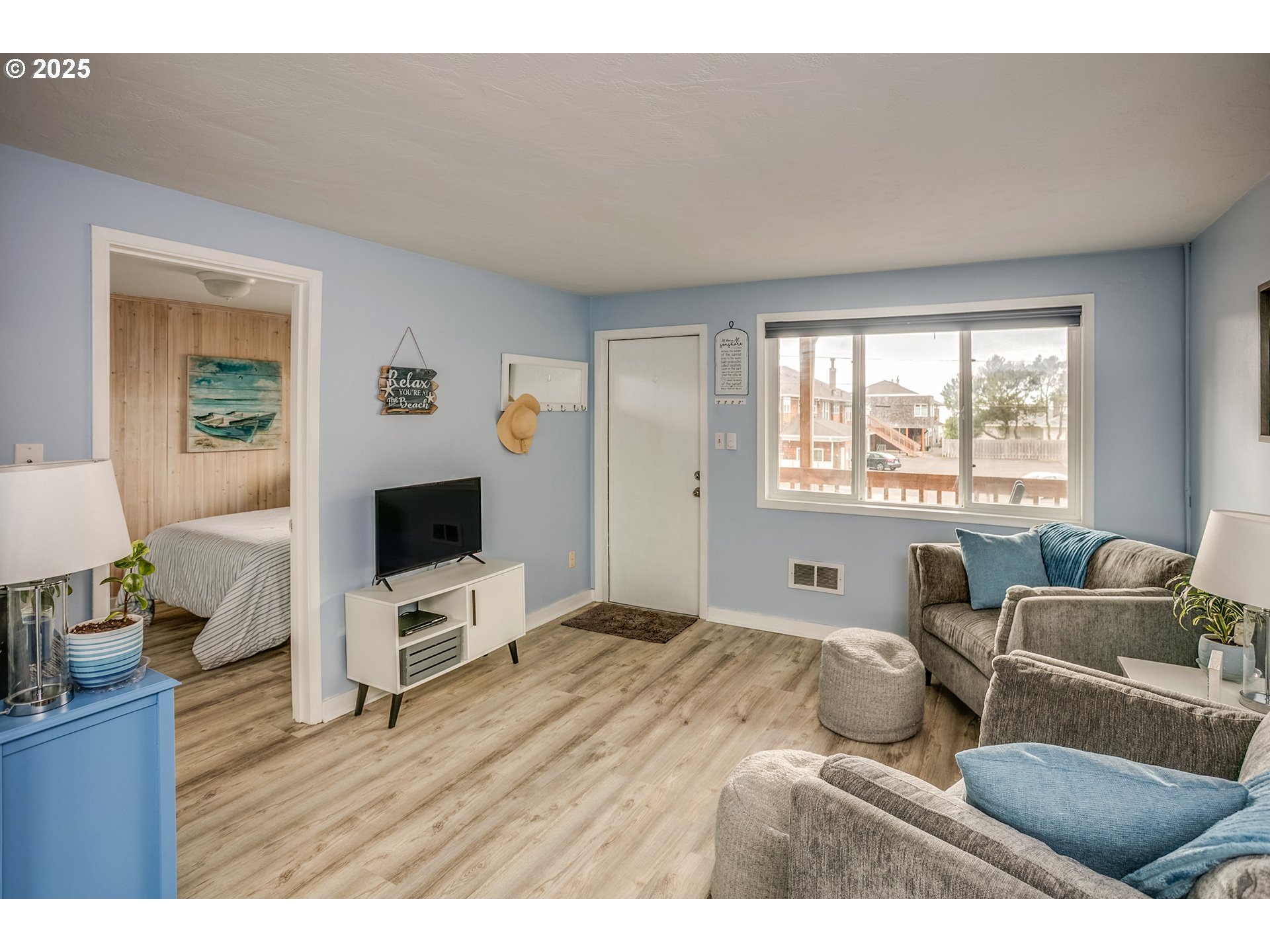 2233 Beach Drive, Unit 40 Seaside, OR 97138 - Photo 11 of 18 a living room with furniture and a flat screen tv