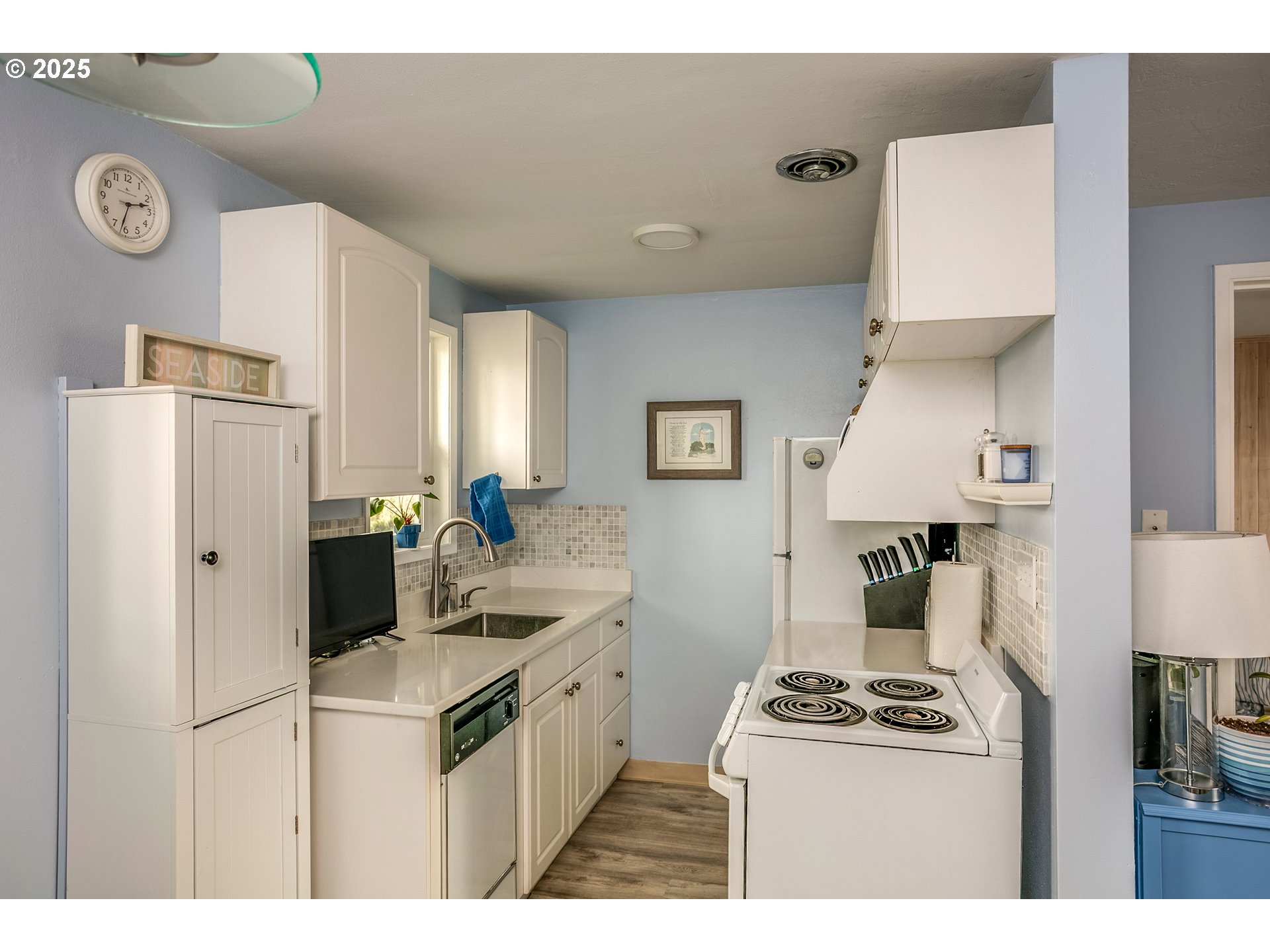 2233 Beach Drive, Unit 40 Seaside, OR 97138 - Photo 12 of 18 a kitchen with stainless steel appliances granite countertop a stove a refrigerator a sink and a refrigerator