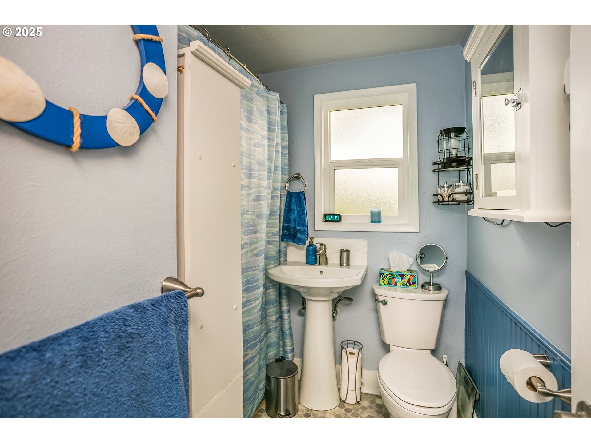 2233 Beach Drive, Unit 40 Seaside, OR 97138 - Photo 15 of 18 a bathroom with a toilet sink and mirror