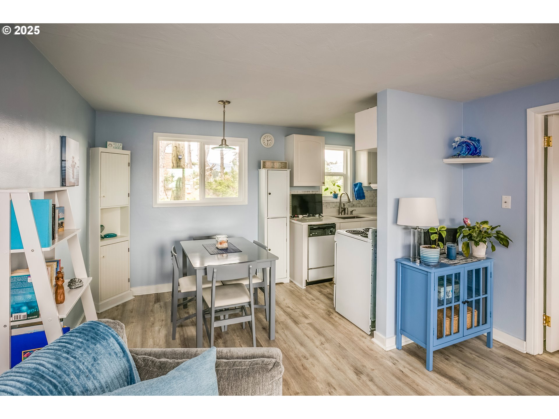 2233 Beach Drive, Unit 40 Seaside, OR 97138 - Photo 9 of 18 a living room with furniture and a dining table with kitchen appliances