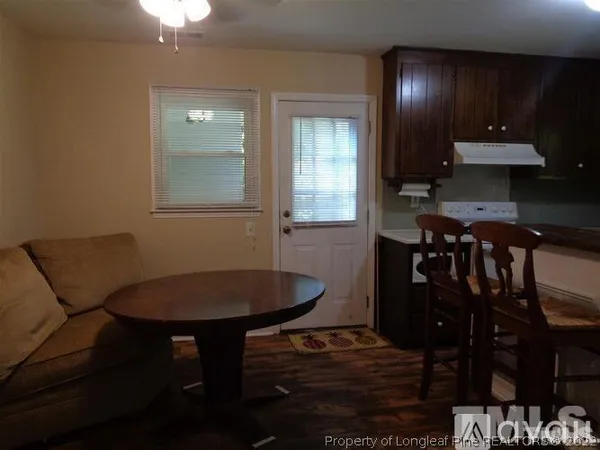 a dining room with furniture and wooden floor
