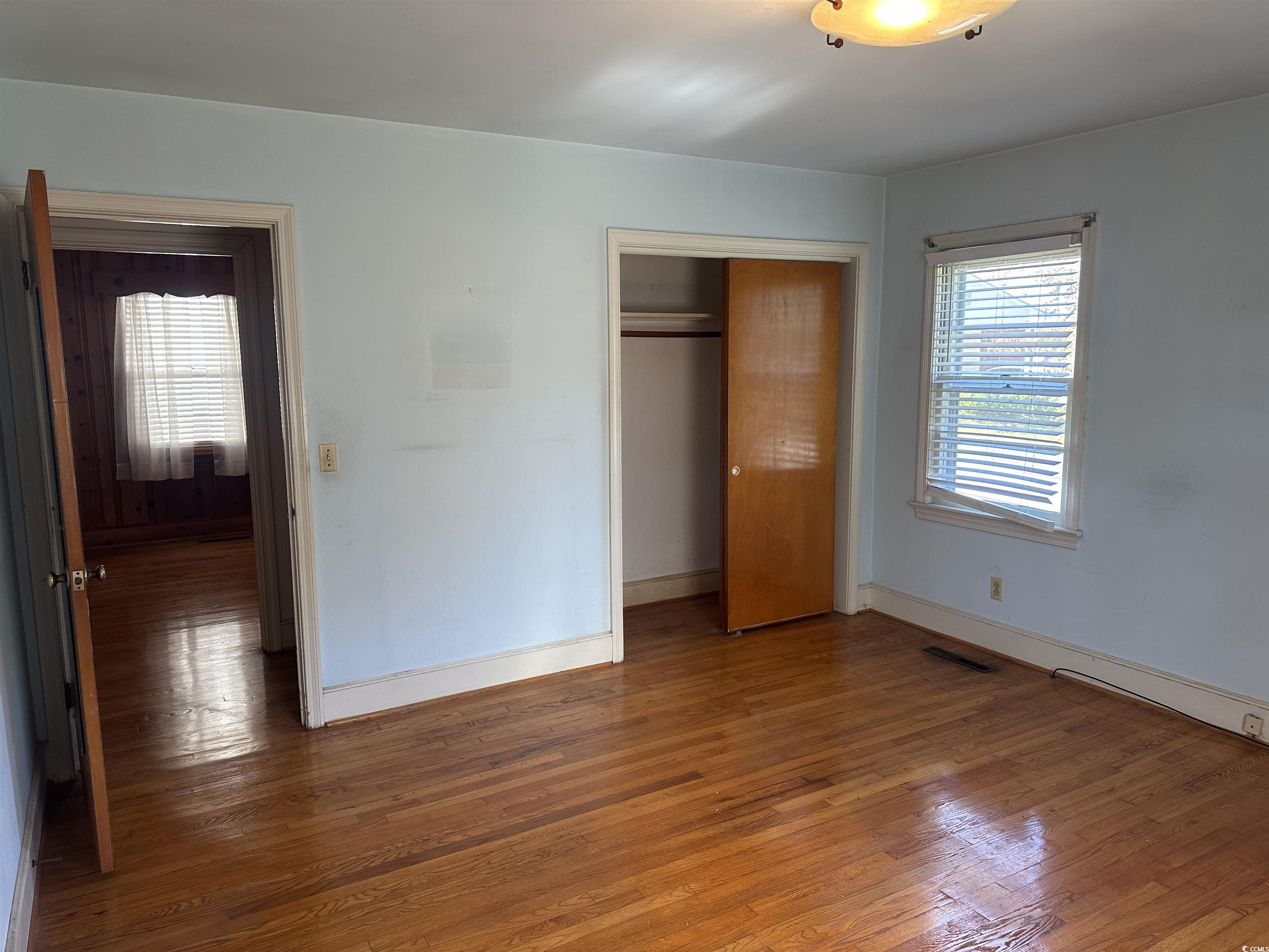 103 East 2nd Avenue Lake View, SC 29563 - Photo 13 of 16 Unfurnished bedroom featuring wood-type flooring and a closet