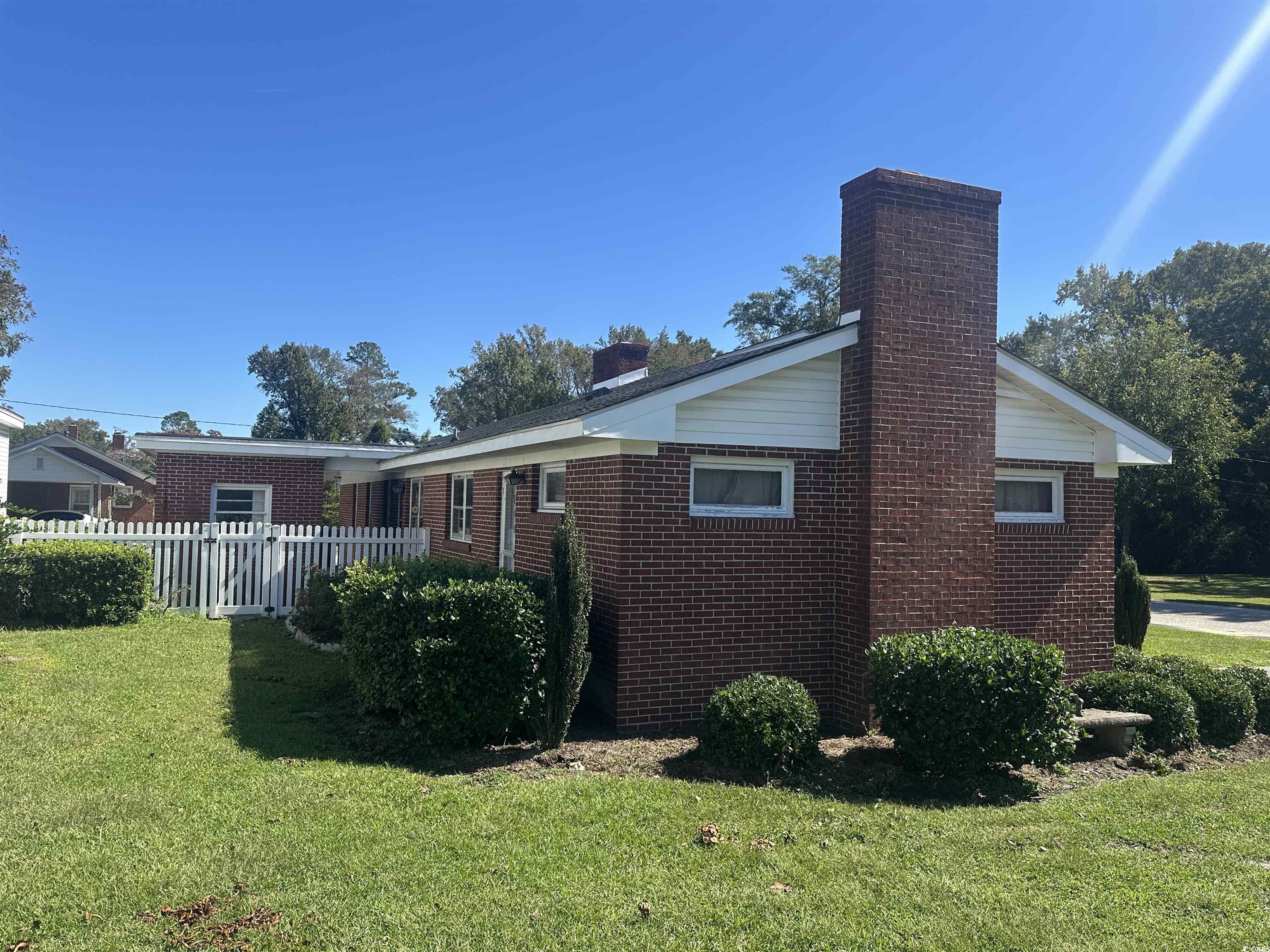 103 East 2nd Avenue Lake View, SC 29563 - Photo 2 of 16 View of property exterior with a chimney and brick siding