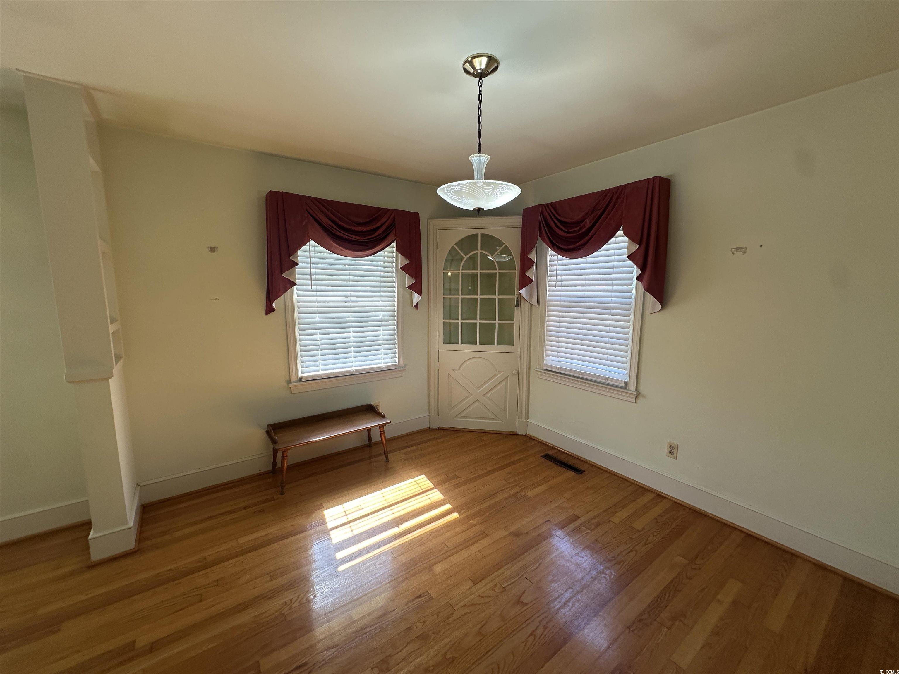 103 East 2nd Avenue Lake View, SC 29563 - Photo 7 of 16 Unfurnished dining area featuring plenty of natural light and wood finished floors