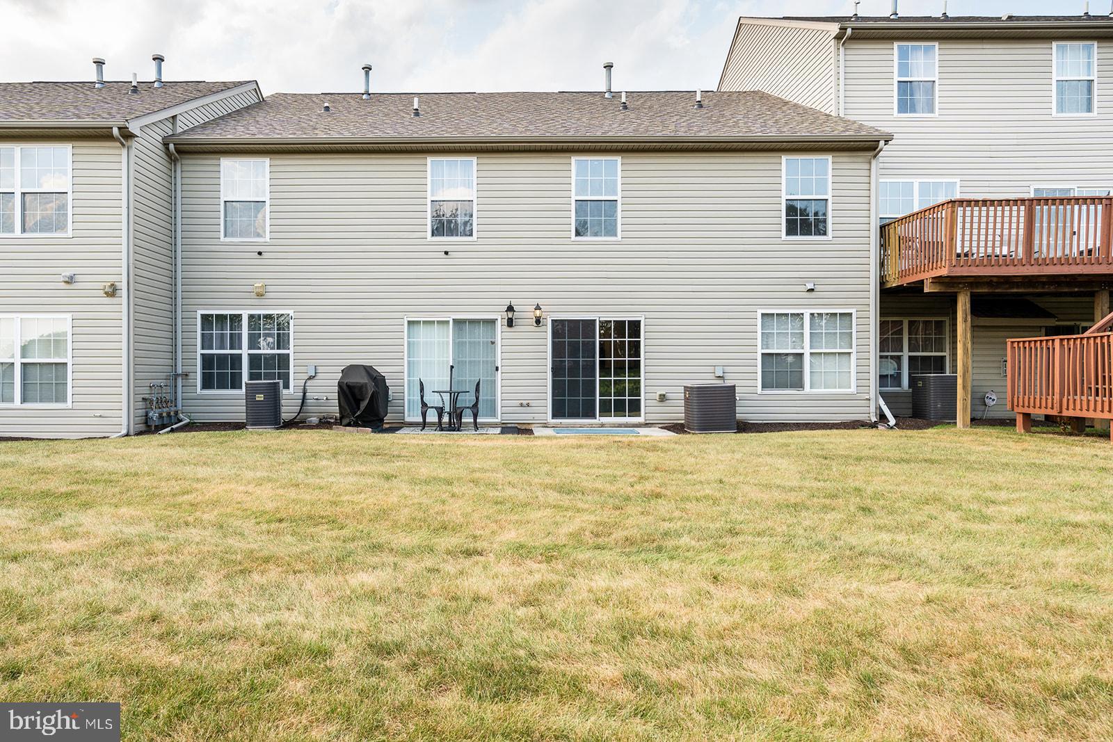 112 Hawk Court Hummelstown, PA 17036 - Photo 23 of 32 a view of a house with a backyard and a table and chair
