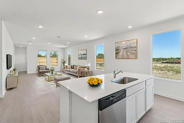 a kitchen with counter space appliances and living room