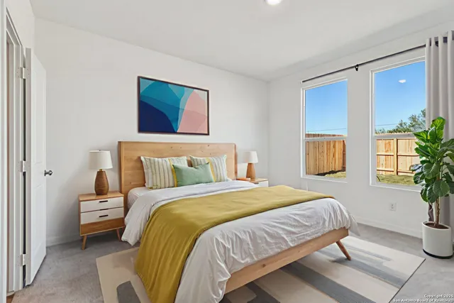 a bedroom with a bed and a potted plant