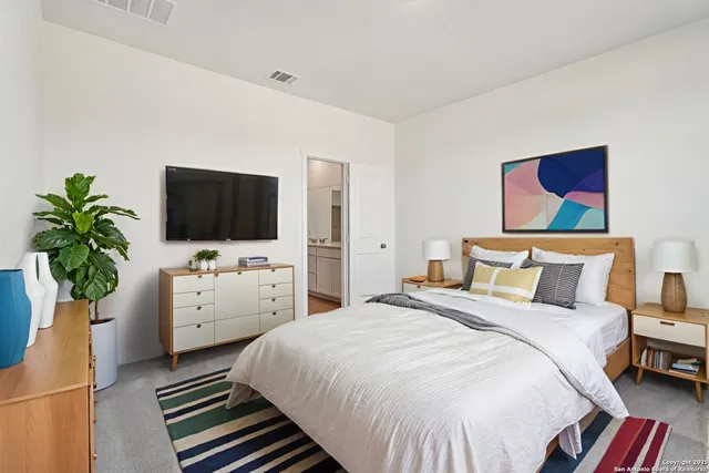 a bedroom with a bed and a flat screen tv