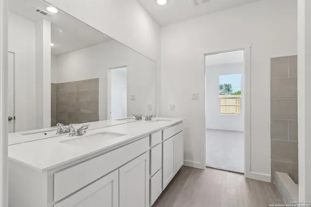 a bathroom with a sink and a mirror