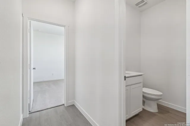 a bathroom with a sink a toilet and mirror