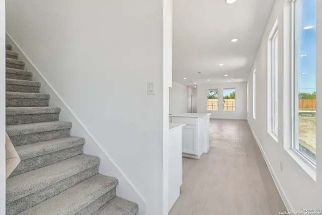 a view of entryway and hall with wooden floor