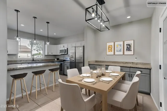 a kitchen with a dining table and chairs