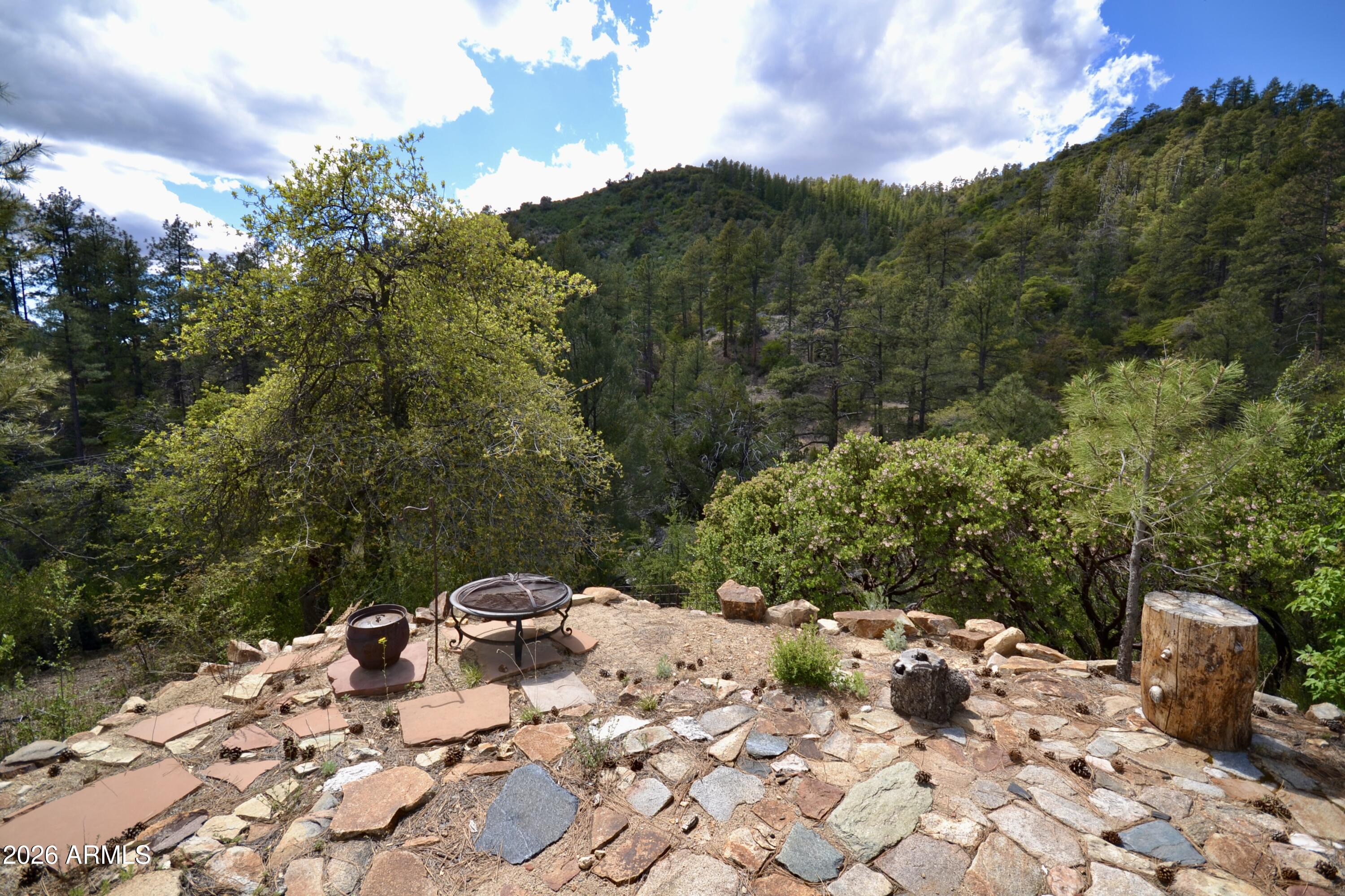 23617 South Demascus Road Crown King, AZ 86343 - Photo 14 of 50 a view of a backyard with a table and chairs