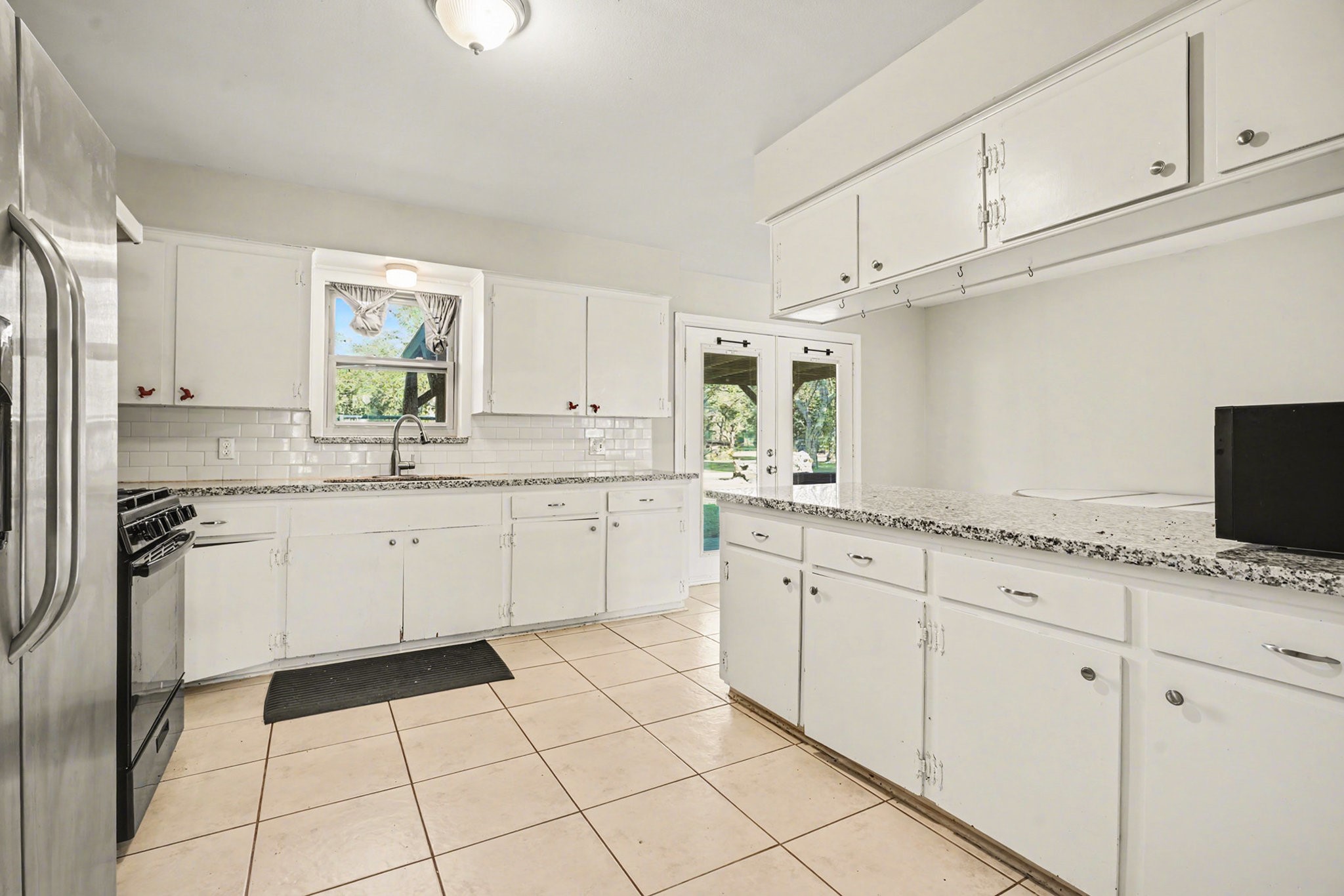 4802 Crosby Cedar Bayou Road Baytown, TX 77521 - Photo 12 of 28 a kitchen with granite countertop white cabinets and white appliances