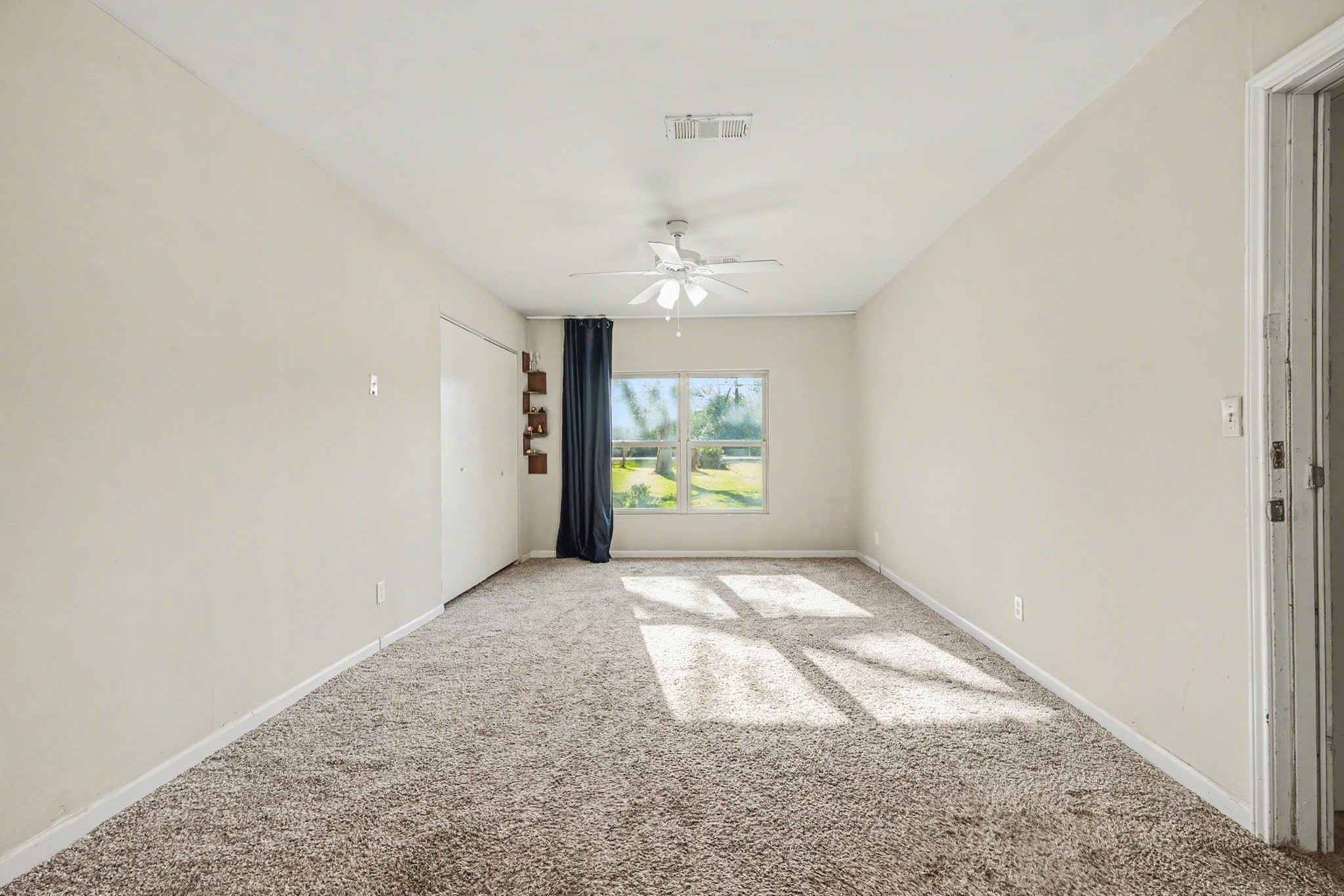 4802 Crosby Cedar Bayou Road Baytown, TX 77521 - Photo 13 of 28 an empty room with windows and fan