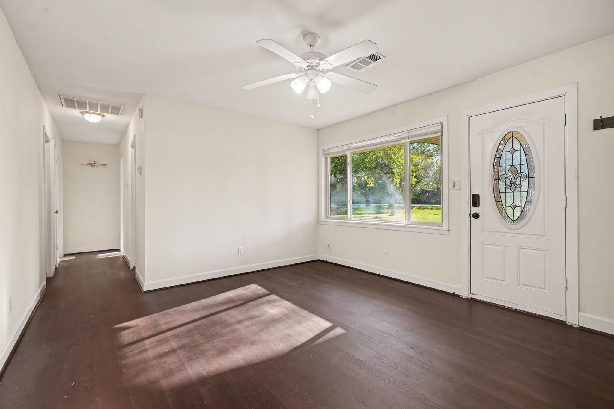 4802 Crosby Cedar Bayou Road Baytown, TX 77521 - Photo 5 of 28 an empty room with windows and ceiling fan