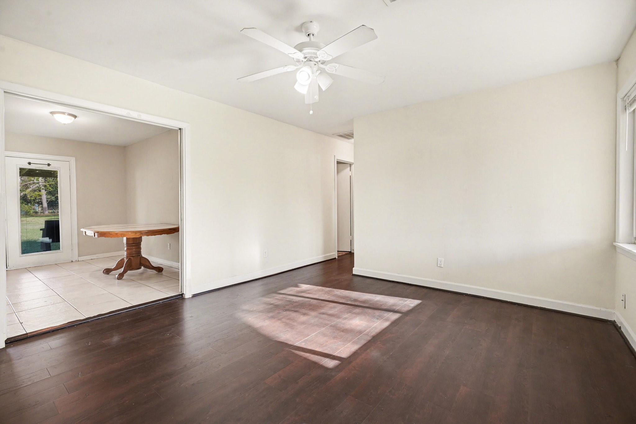 4802 Crosby Cedar Bayou Road Baytown, TX 77521 - Photo 6 of 28 wooden floor in an empty room with a window