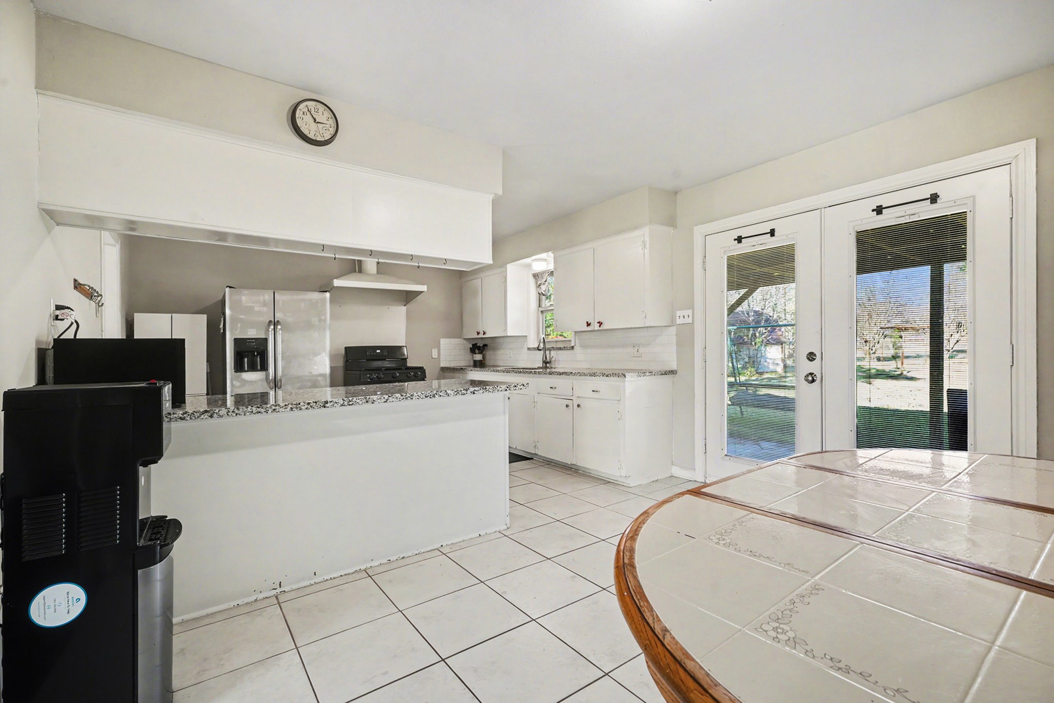 4802 Crosby Cedar Bayou Road Baytown, TX 77521 - Photo 8 of 28 a kitchen with stainless steel appliances kitchen island granite countertop a sink and cabinets
