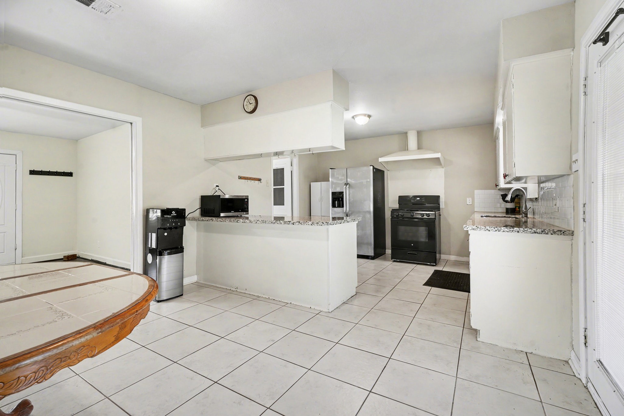4802 Crosby Cedar Bayou Road Baytown, TX 77521 - Photo 9 of 28 a kitchen with a refrigerator and a stove top oven