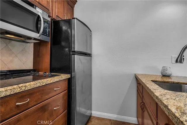 a bathroom with a granite countertop toilet sink and mirror